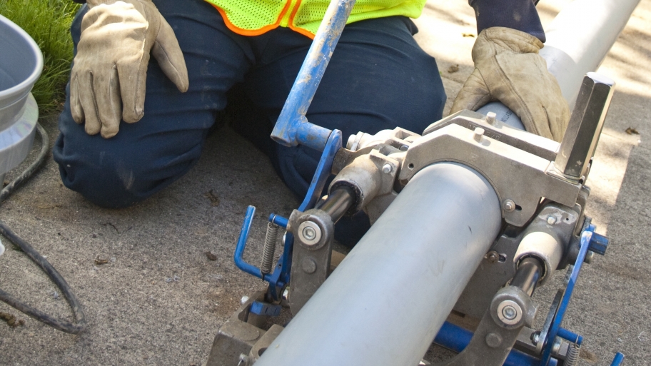 Trenchless sewer replacement worker